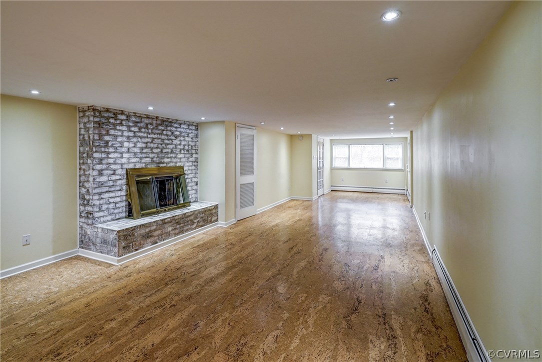4208 Croatan Road Richmond, VA 23235 - Photo 41 of 50 an empty room with wooden floor fireplace and windows