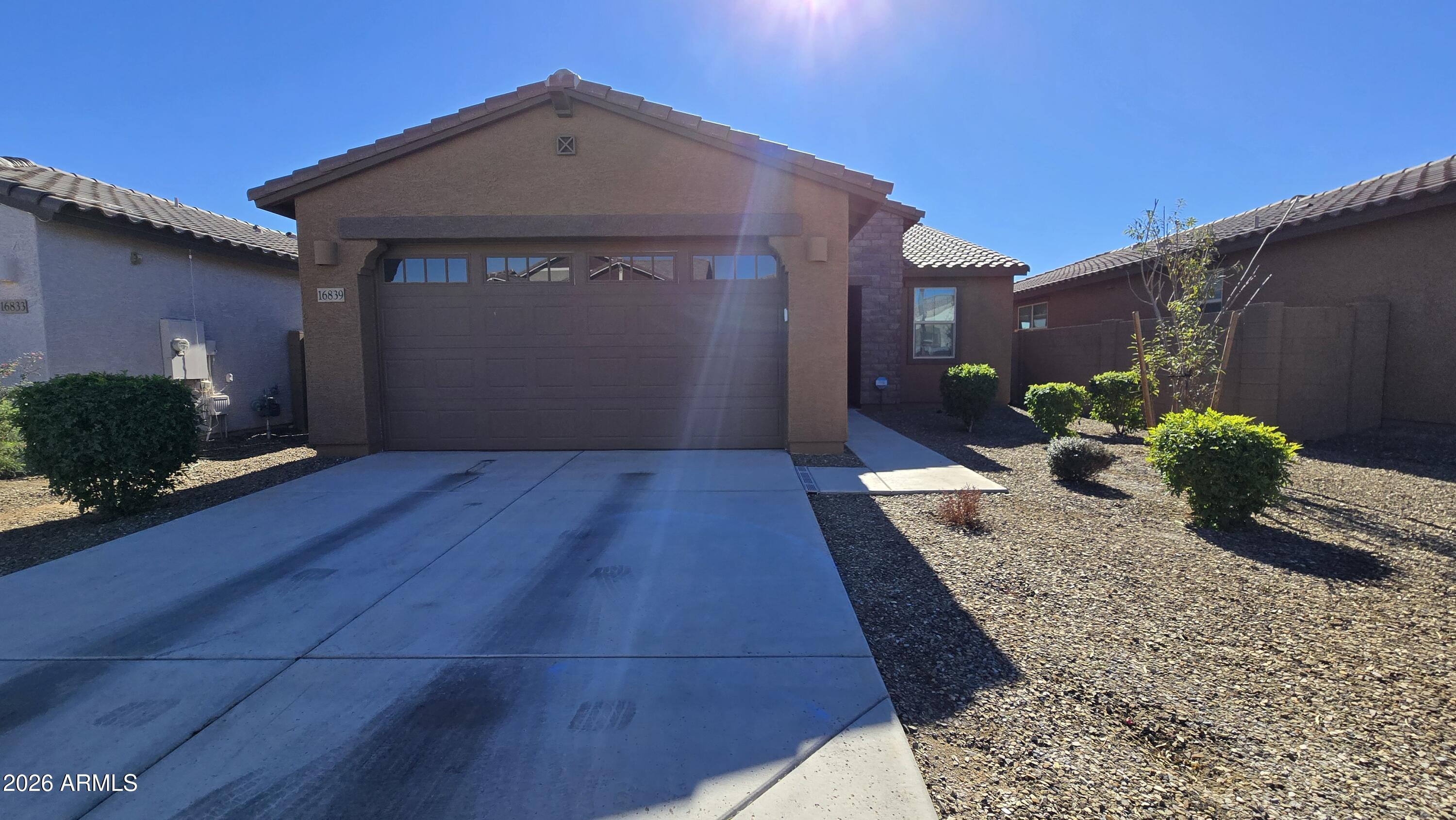 16839 West Evergreen Road Waddell, AZ 85355 - Photo 1 of 28 a front view of a house with a yard