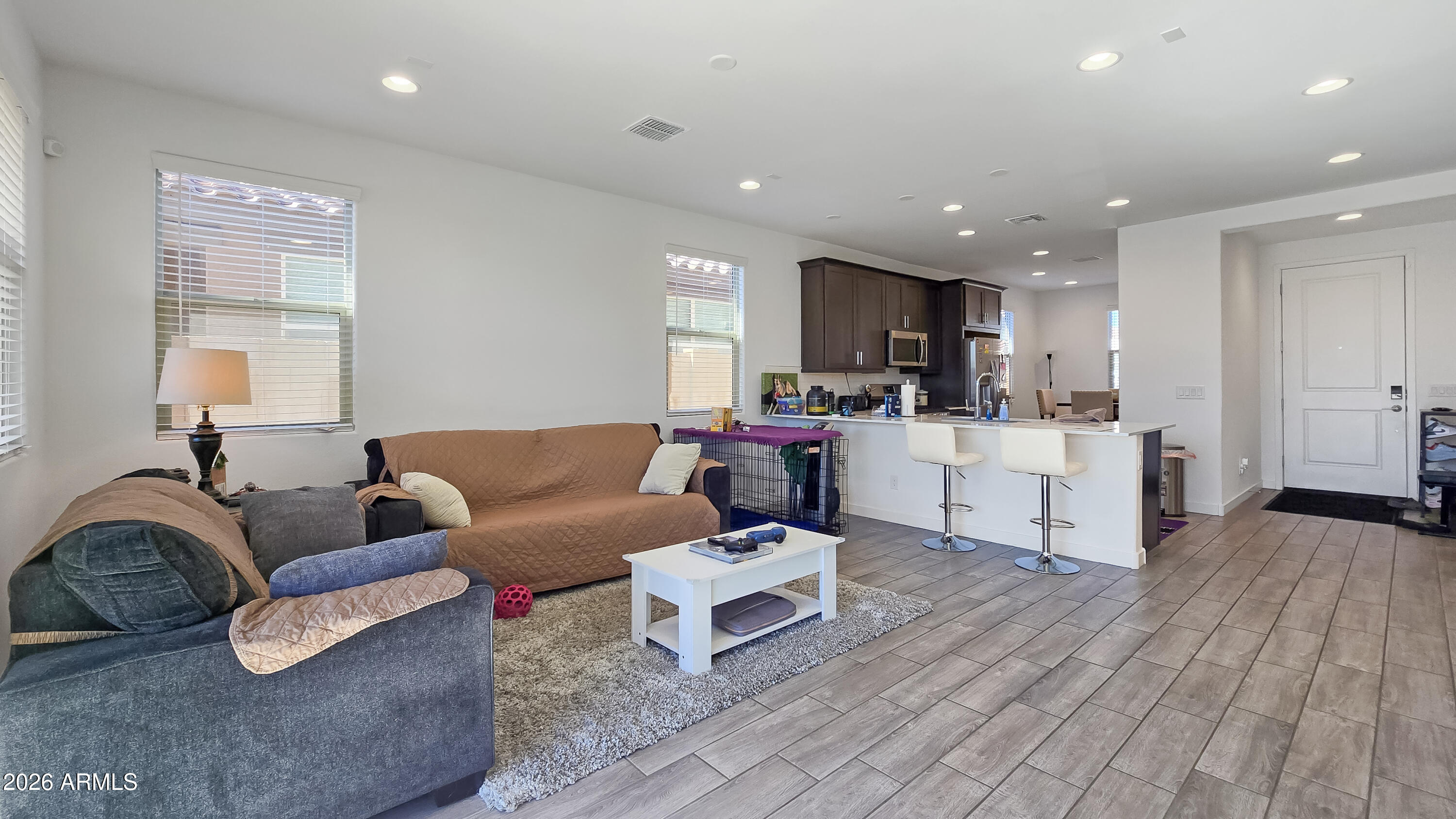 16839 West Evergreen Road Waddell, AZ 85355 - Photo 13 of 28 a living room with furniture and kitchen view