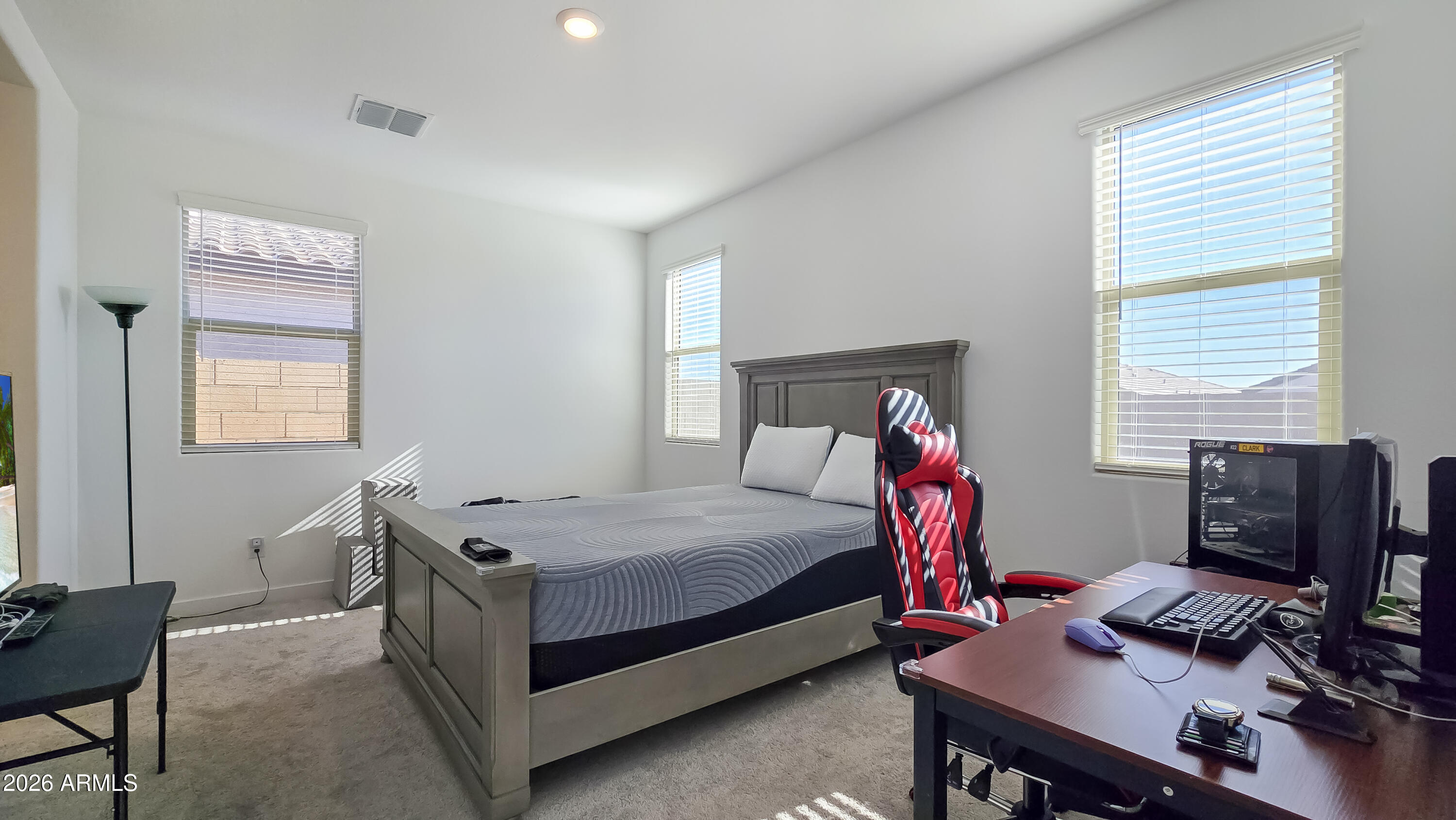 16839 West Evergreen Road Waddell, AZ 85355 - Photo 14 of 28 a bedroom with a bed and a window