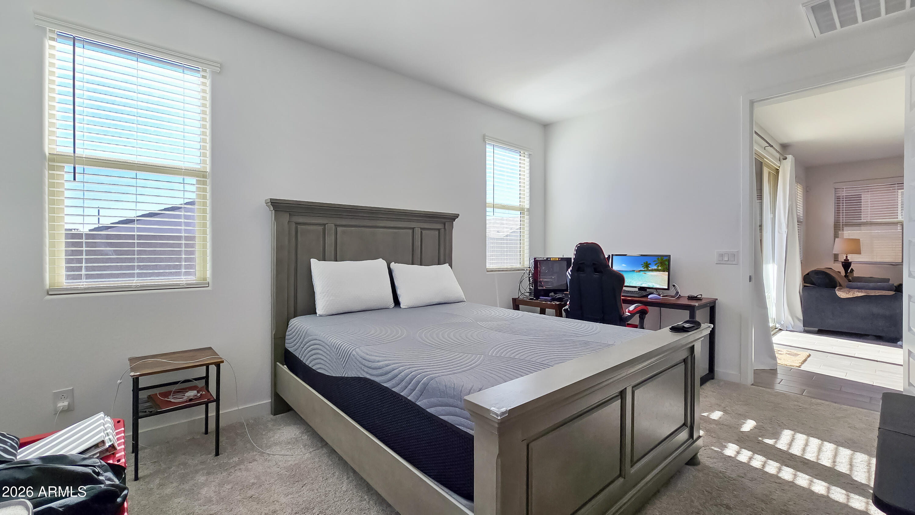 16839 West Evergreen Road Waddell, AZ 85355 - Photo 15 of 28 a bedroom with a bed and a desk