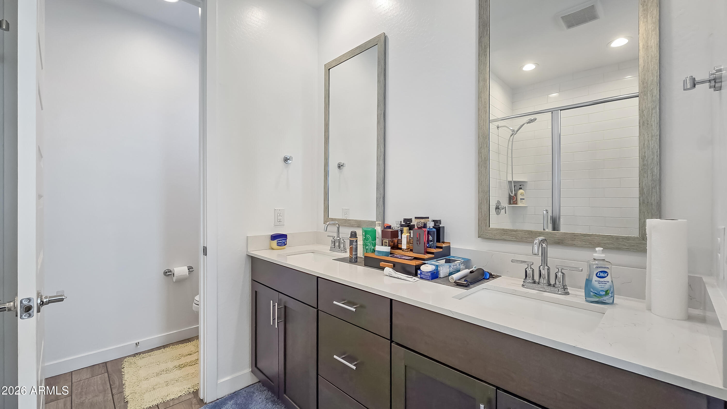 16839 West Evergreen Road Waddell, AZ 85355 - Photo 17 of 28 a bathroom with double vanity sink a mirror and a shower