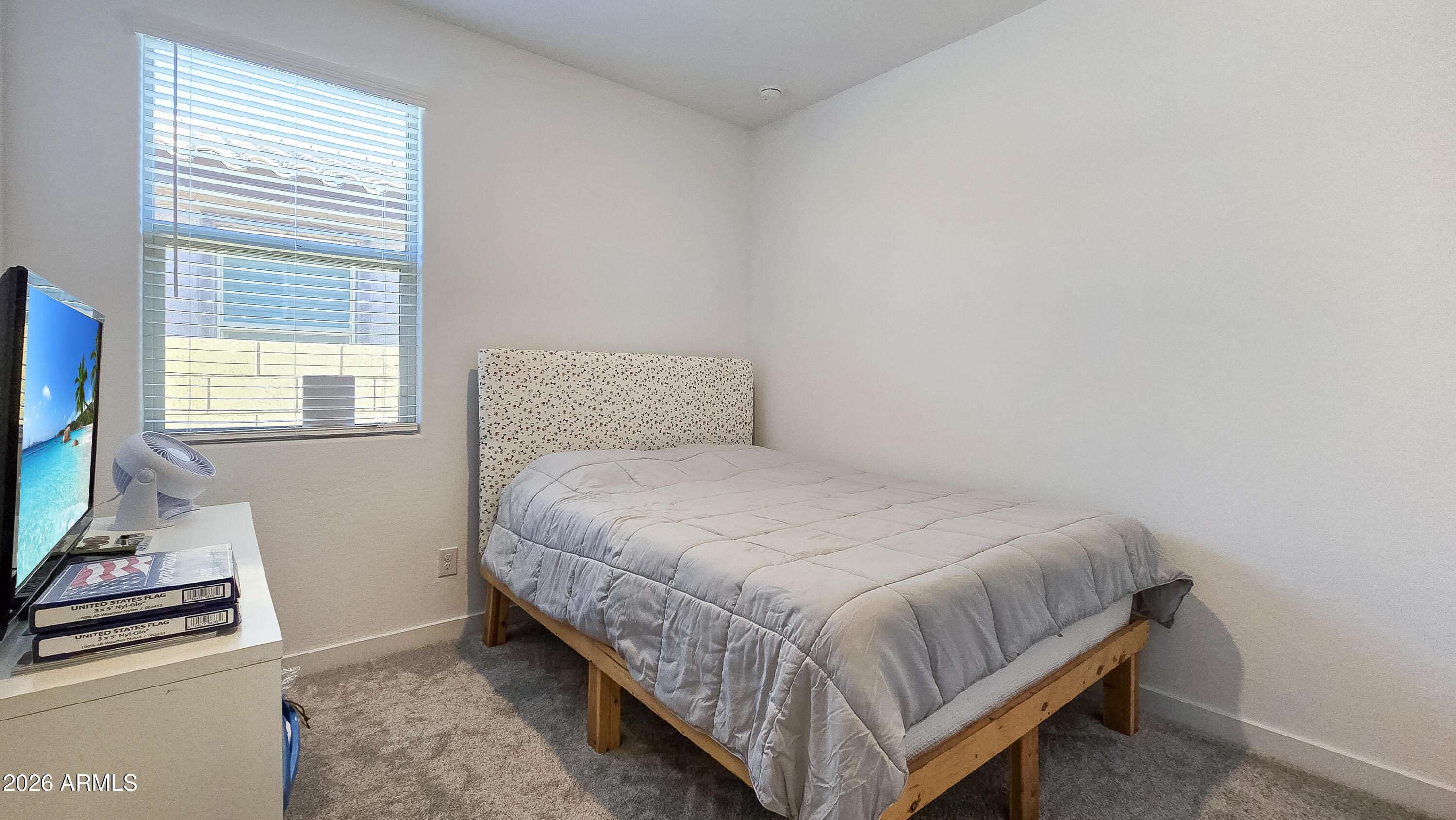 16839 West Evergreen Road Waddell, AZ 85355 - Photo 19 of 28 a bedroom with a bed and flat screen tv