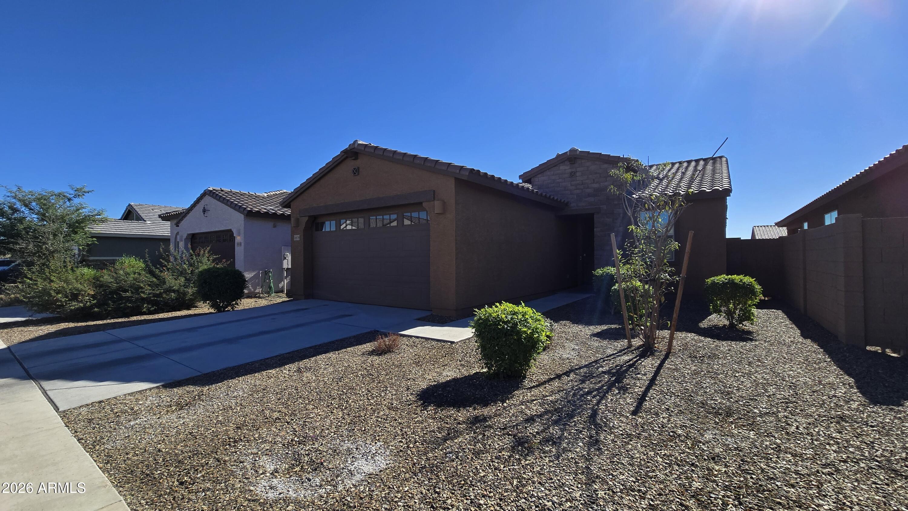 16839 West Evergreen Road Waddell, AZ 85355 - Photo 2 of 28 a front view of a house with garden