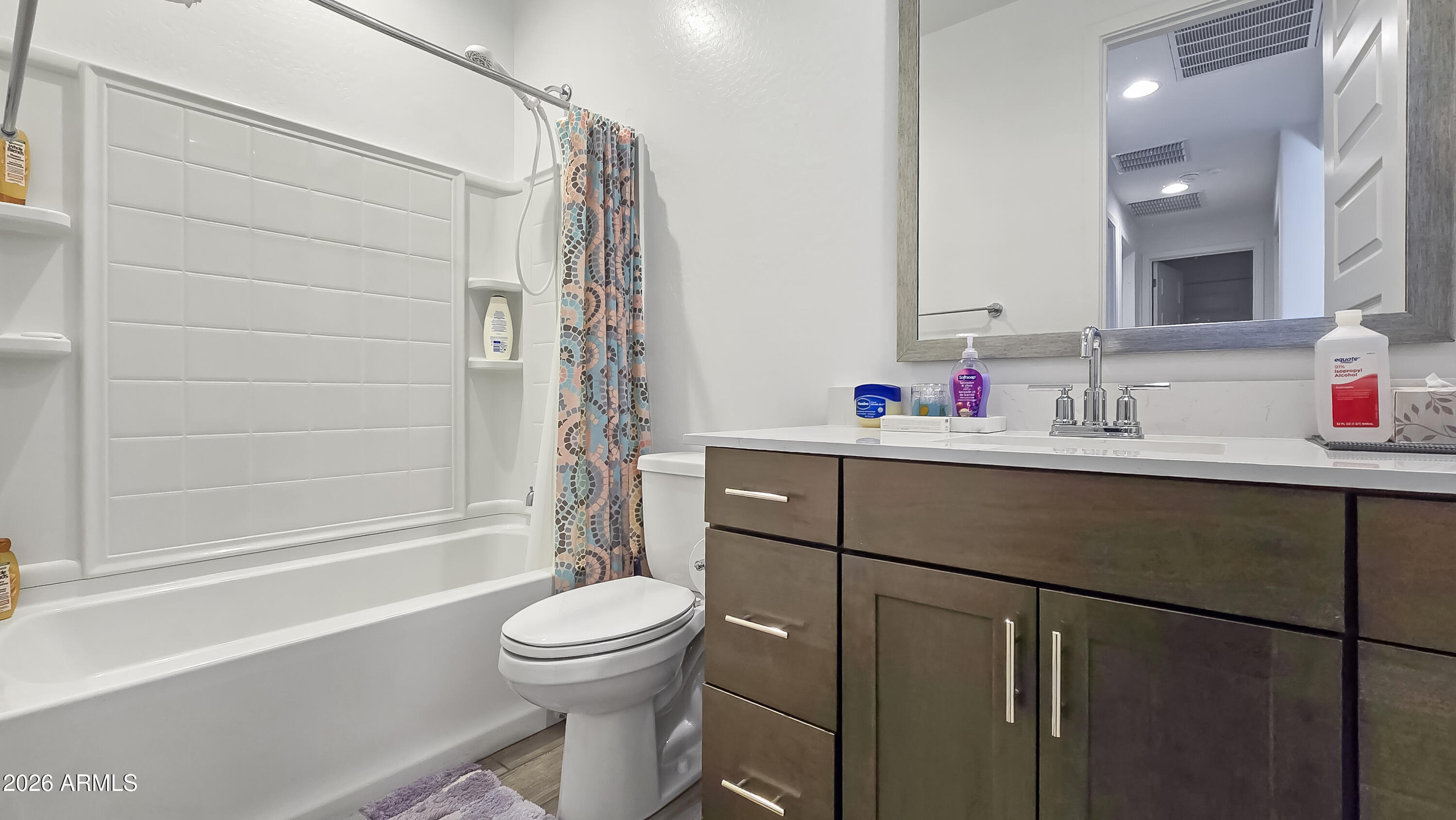 16839 West Evergreen Road Waddell, AZ 85355 - Photo 21 of 28 a bathroom with a sink toilet vanity and shower