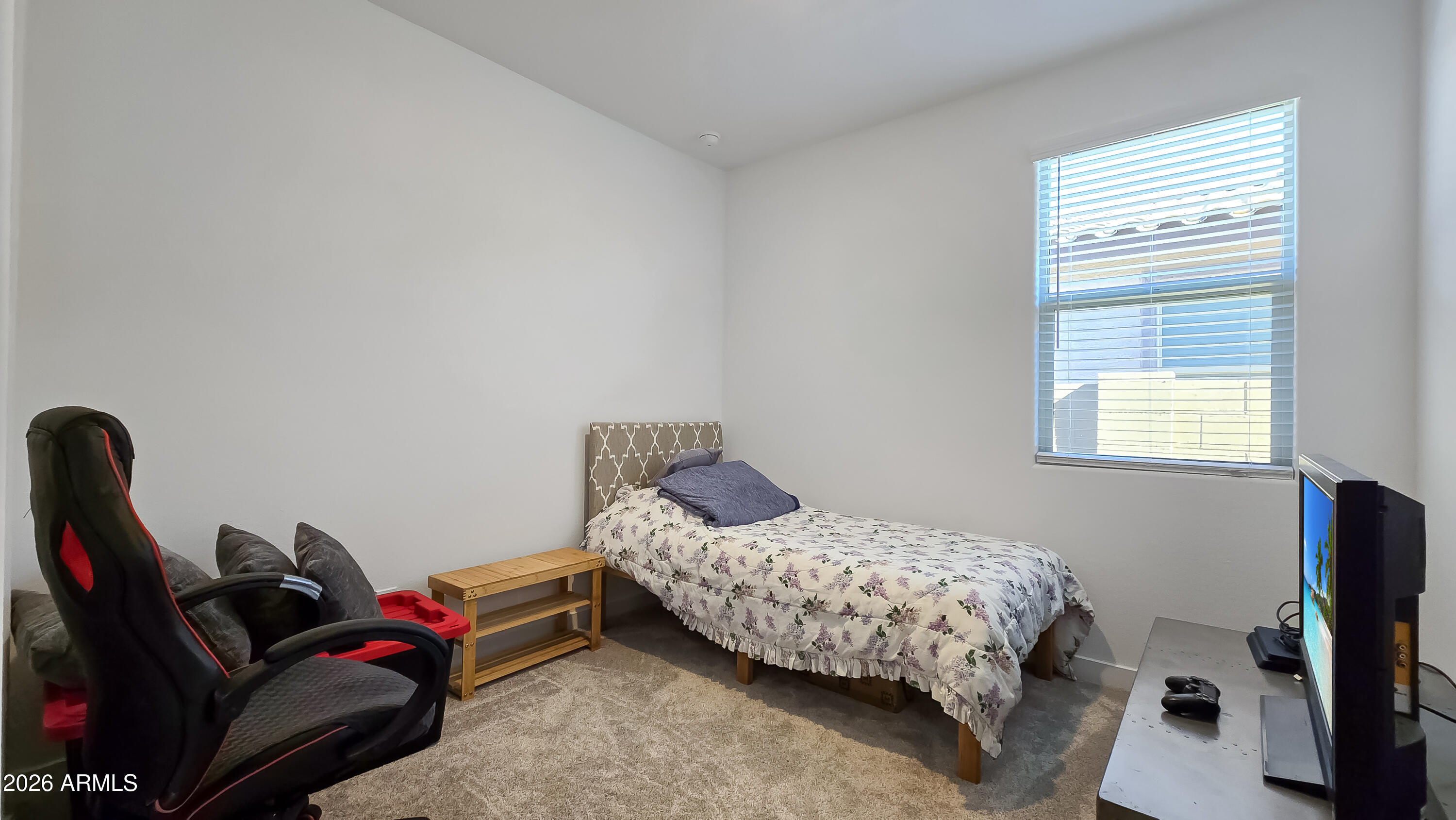 16839 West Evergreen Road Waddell, AZ 85355 - Photo 22 of 28 a bedroom with a bed and a window