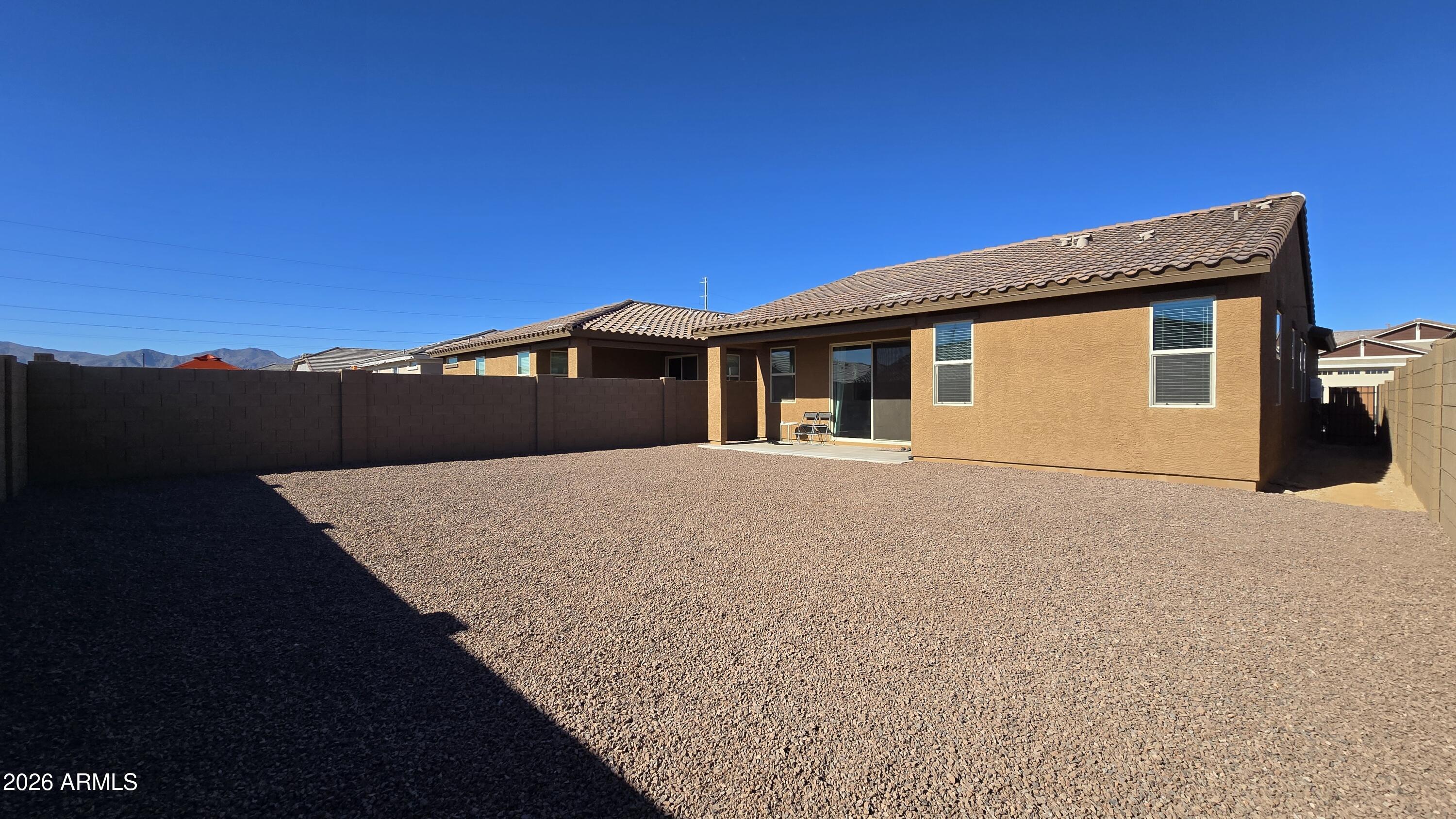 16839 West Evergreen Road Waddell, AZ 85355 - Photo 26 of 28 a front view of a house with a yard