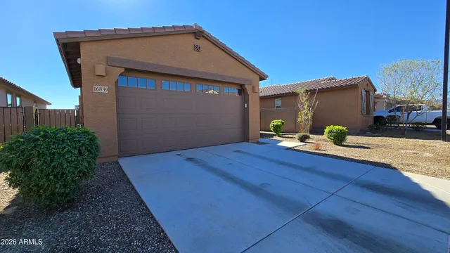 a wooden bench sitting in front of a house