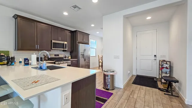 a kitchen with a sink a stove and cabinets
