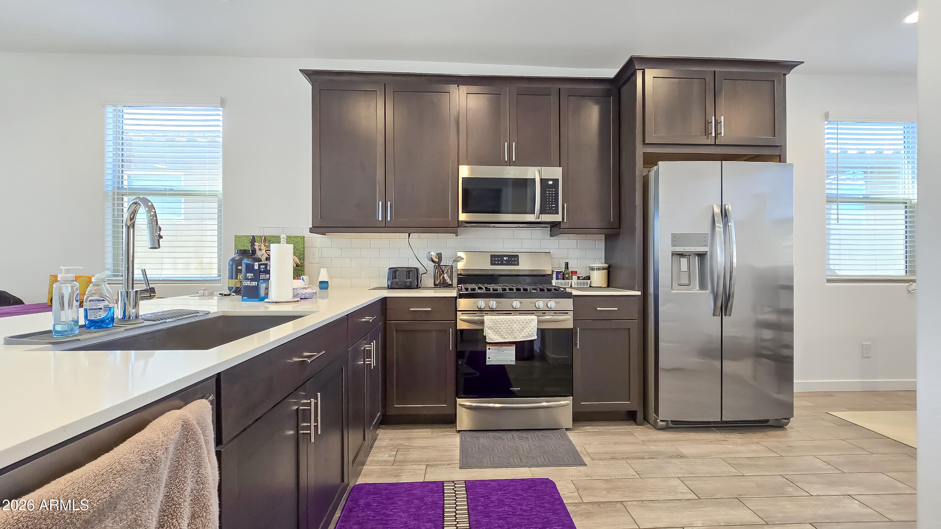 16839 West Evergreen Road Waddell, AZ 85355 - Photo 6 of 28 a kitchen with a refrigerator sink and microwave