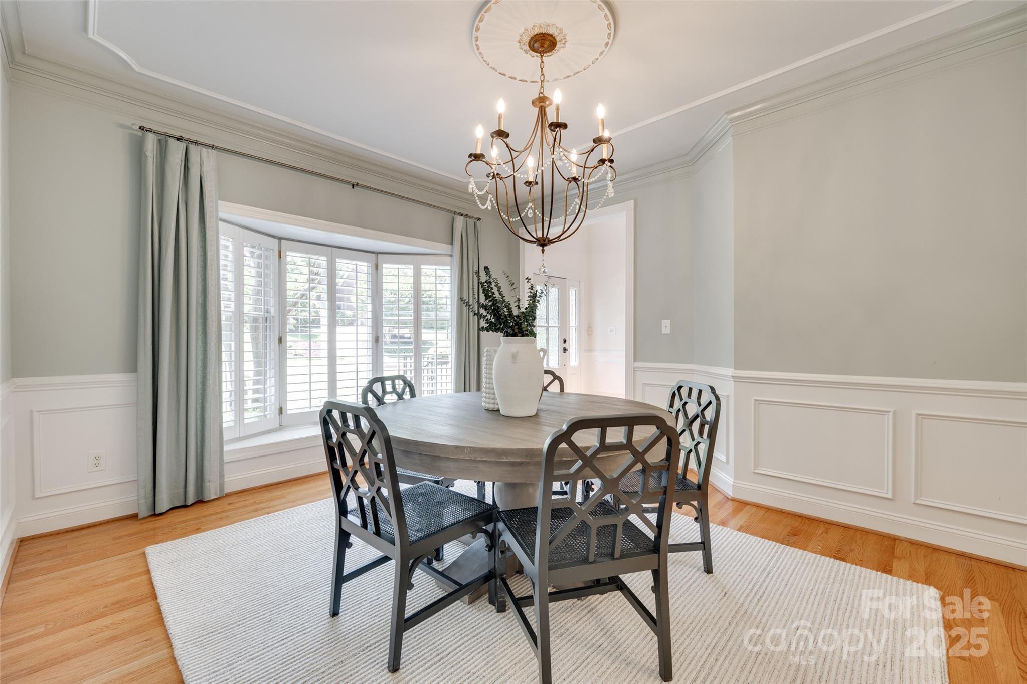 6804 Riesman Lane Charlotte, NC 28210 - Photo 14 of 46 a view of a dining room with furniture a chandelier and wooden floor