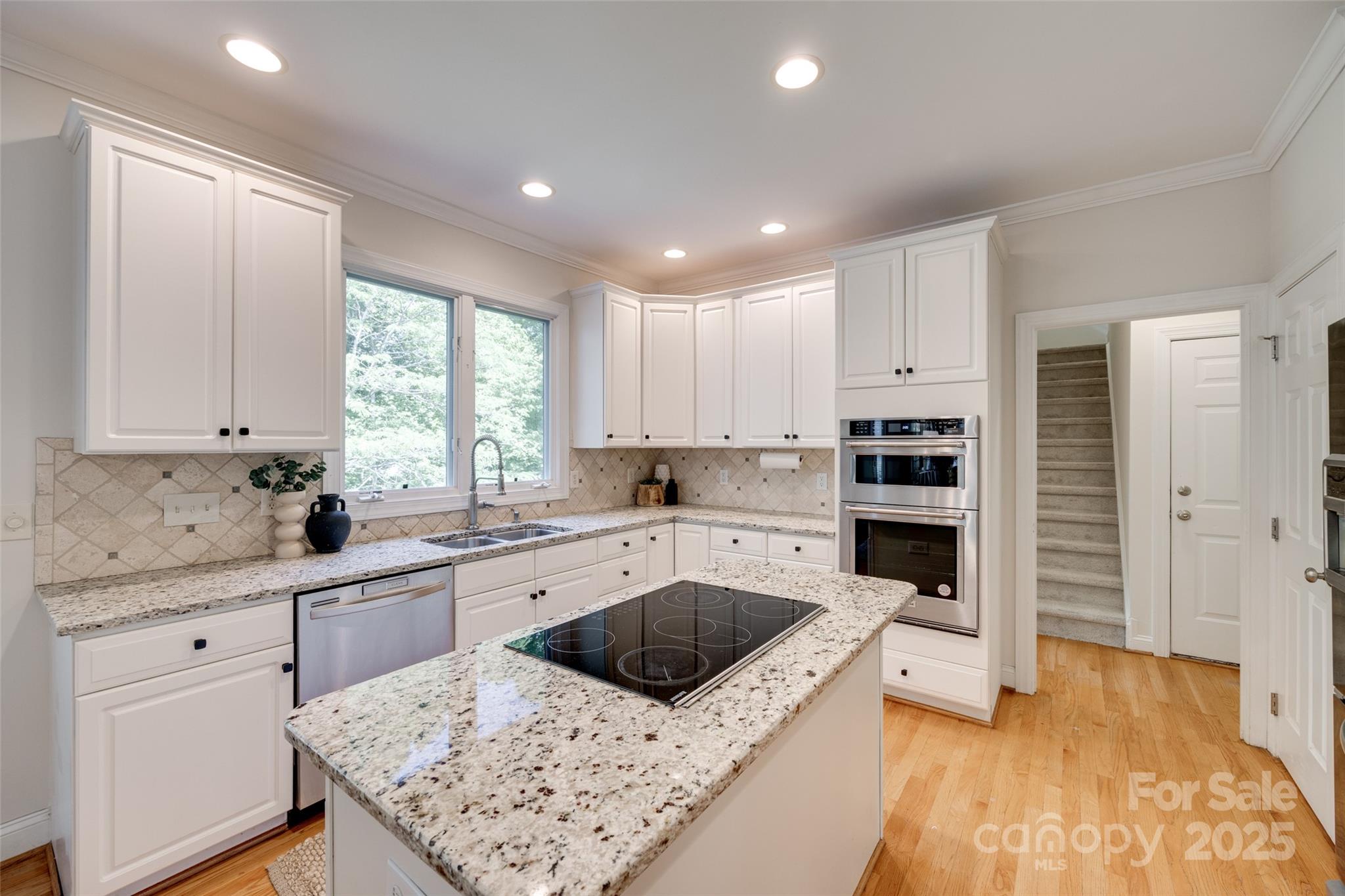 6804 Riesman Lane Charlotte, NC 28210 - Photo 16 of 46 a kitchen with white cabinets sink and stainless steel appliances