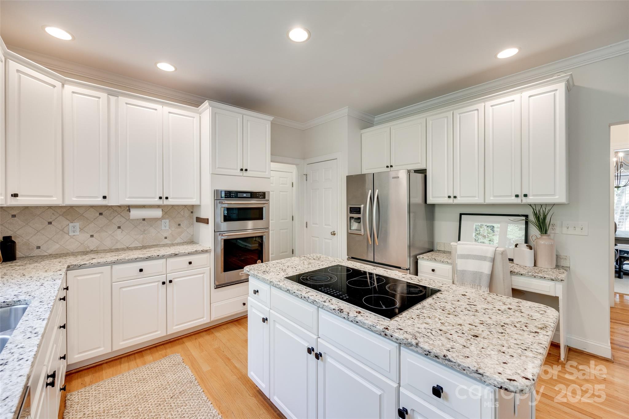 6804 Riesman Lane Charlotte, NC 28210 - Photo 17 of 46 a kitchen with granite countertop white cabinets and stainless steel appliances