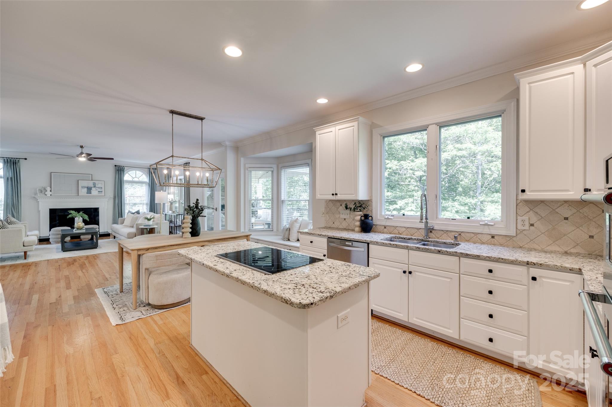 6804 Riesman Lane Charlotte, NC 28210 - Photo 19 of 46 a large kitchen with granite countertop a sink and white cabinets