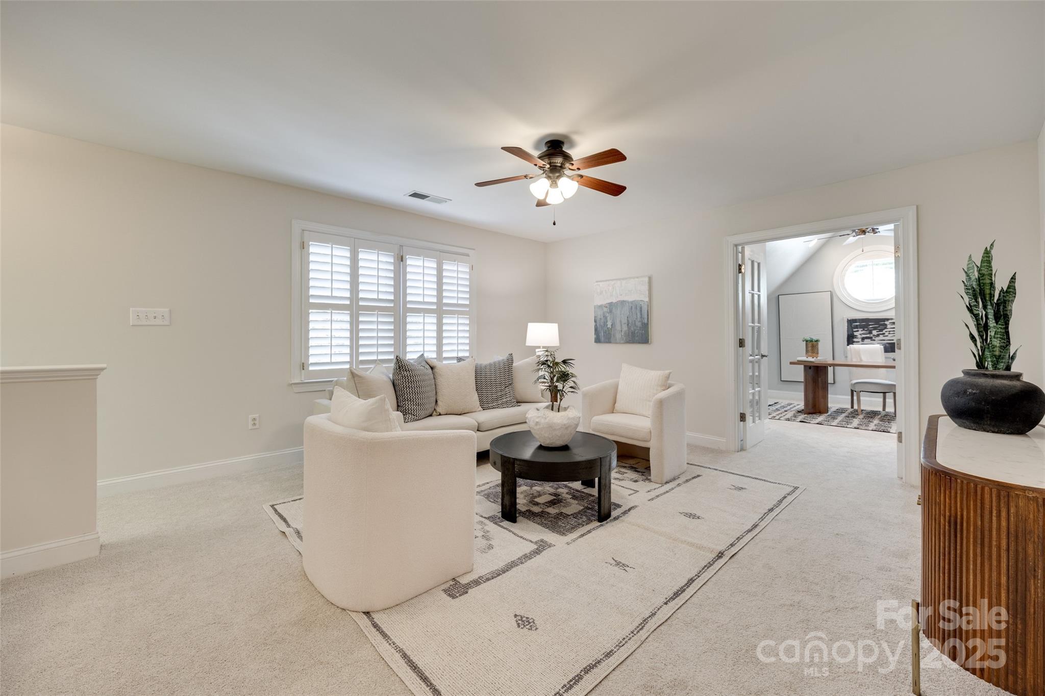 6804 Riesman Lane Charlotte, NC 28210 - Photo 21 of 46 a living room with furniture a chandelier fan and a window