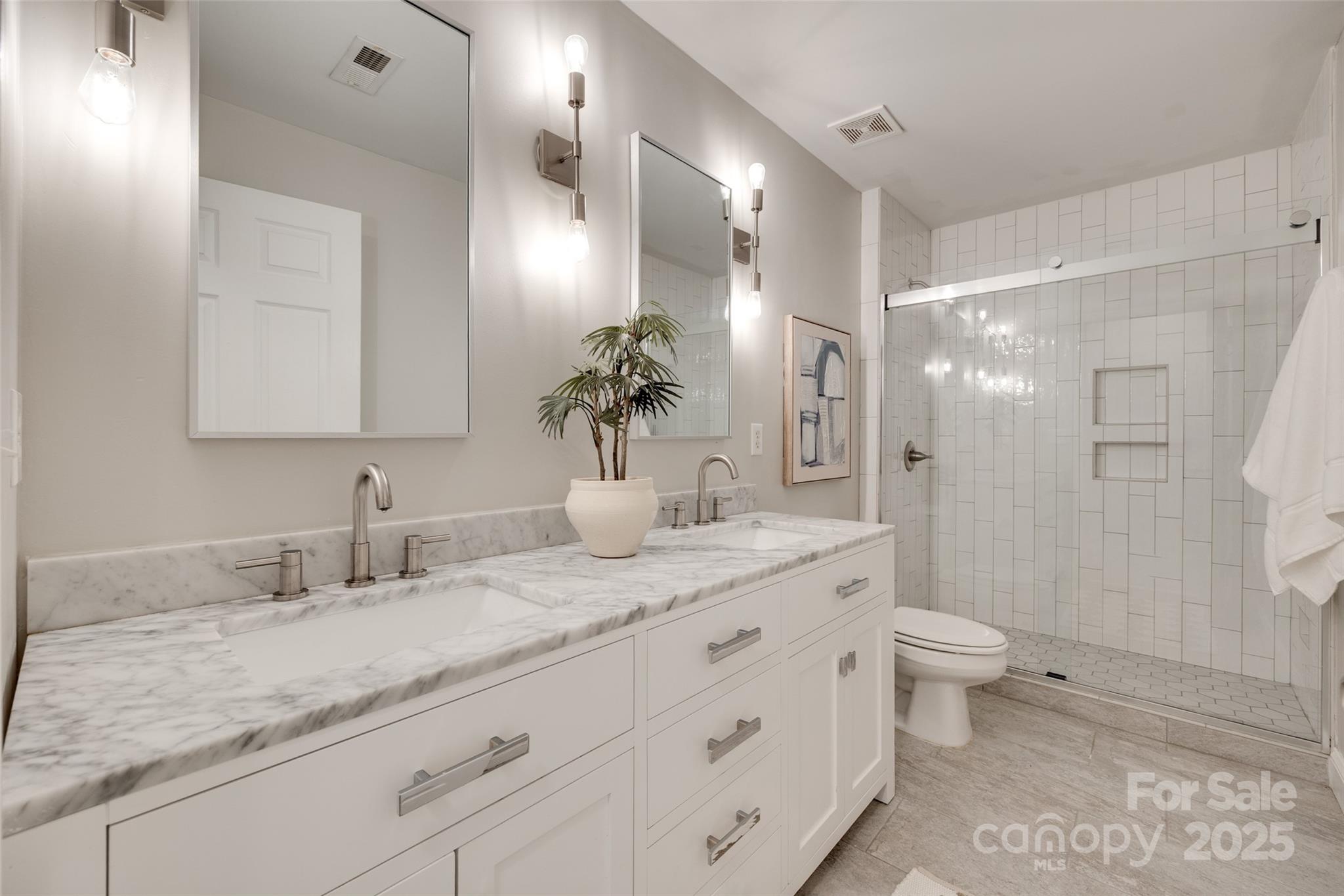6804 Riesman Lane Charlotte, NC 28210 - Photo 29 of 46 a bathroom with a granite countertop sink a toilet and a large mirror