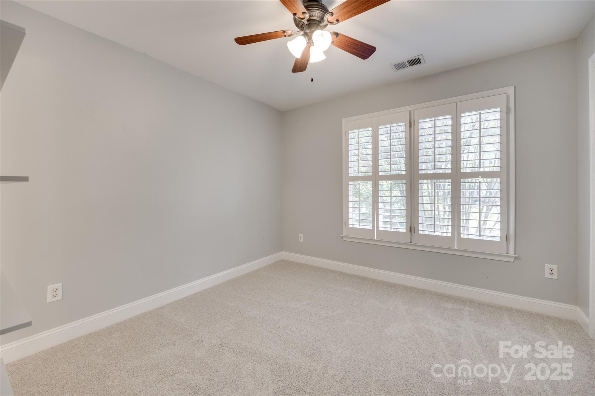 6804 Riesman Lane Charlotte, NC 28210 - Photo 30 of 46 an empty room with a window and a fan