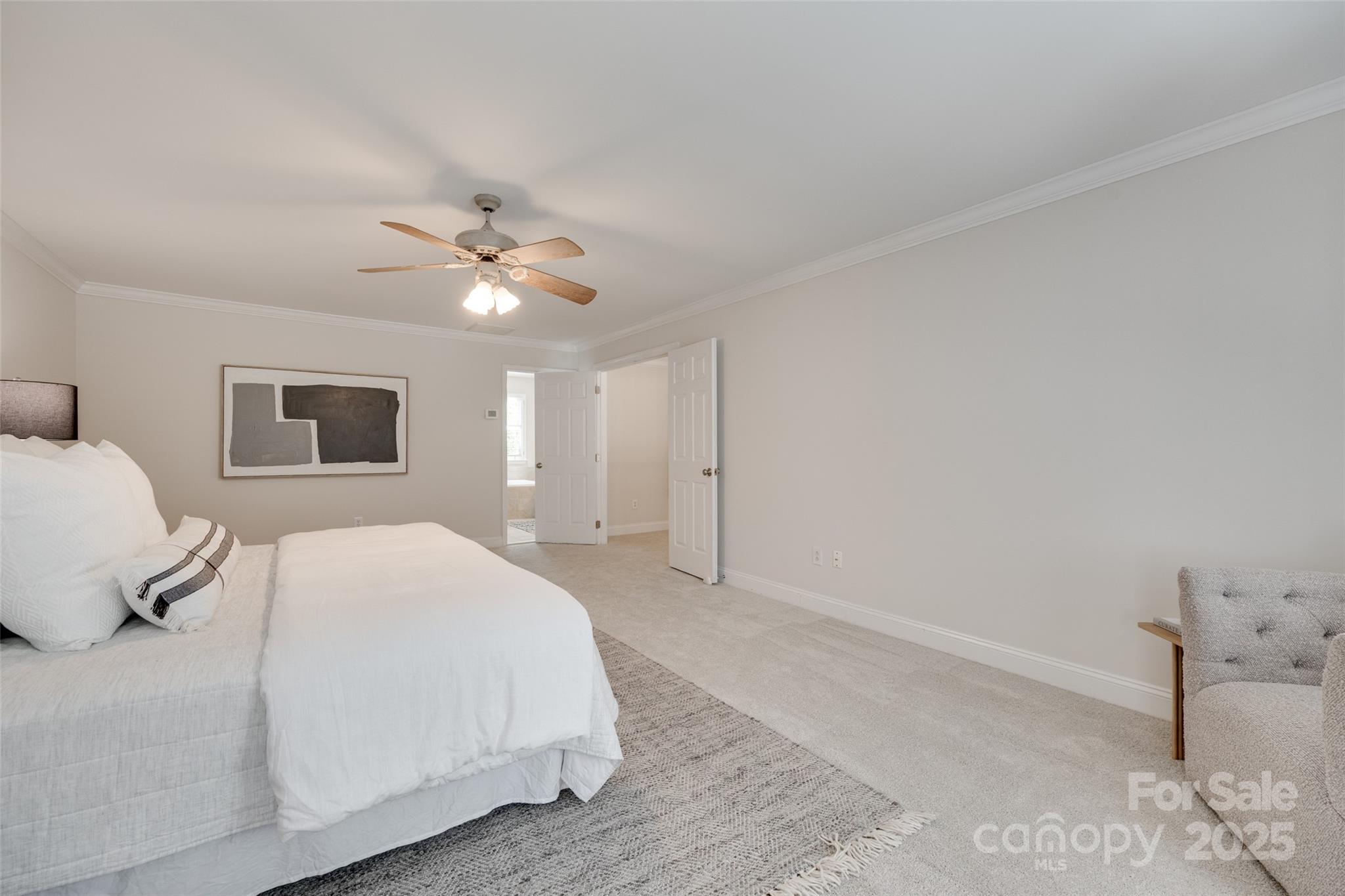6804 Riesman Lane Charlotte, NC 28210 - Photo 34 of 46 a bedroom with a large bed and a ceiling fan