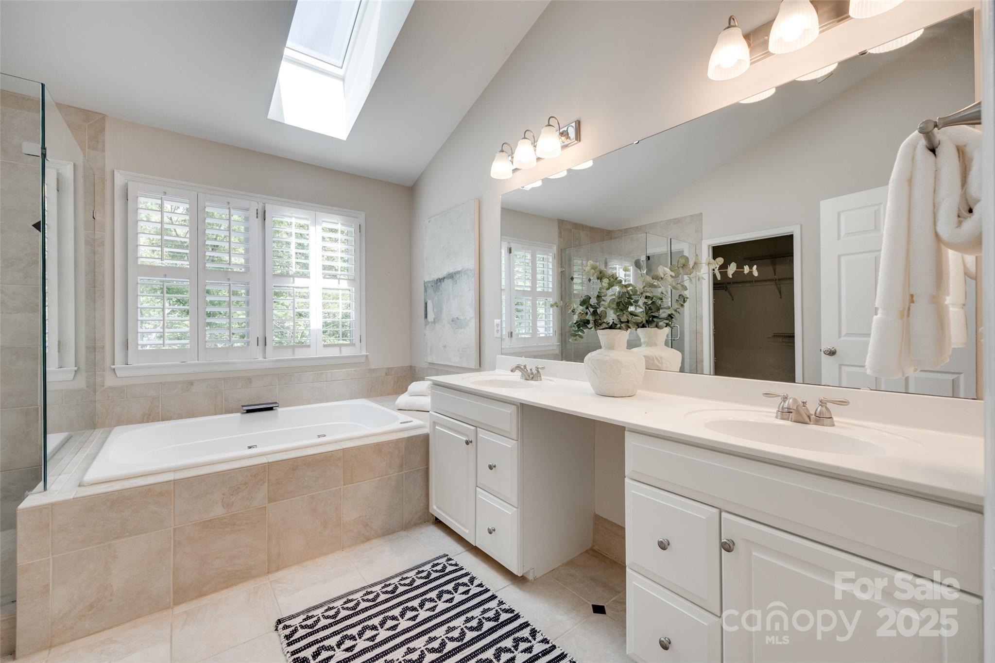 6804 Riesman Lane Charlotte, NC 28210 - Photo 35 of 46 a bathroom with a tub a sink and mirror