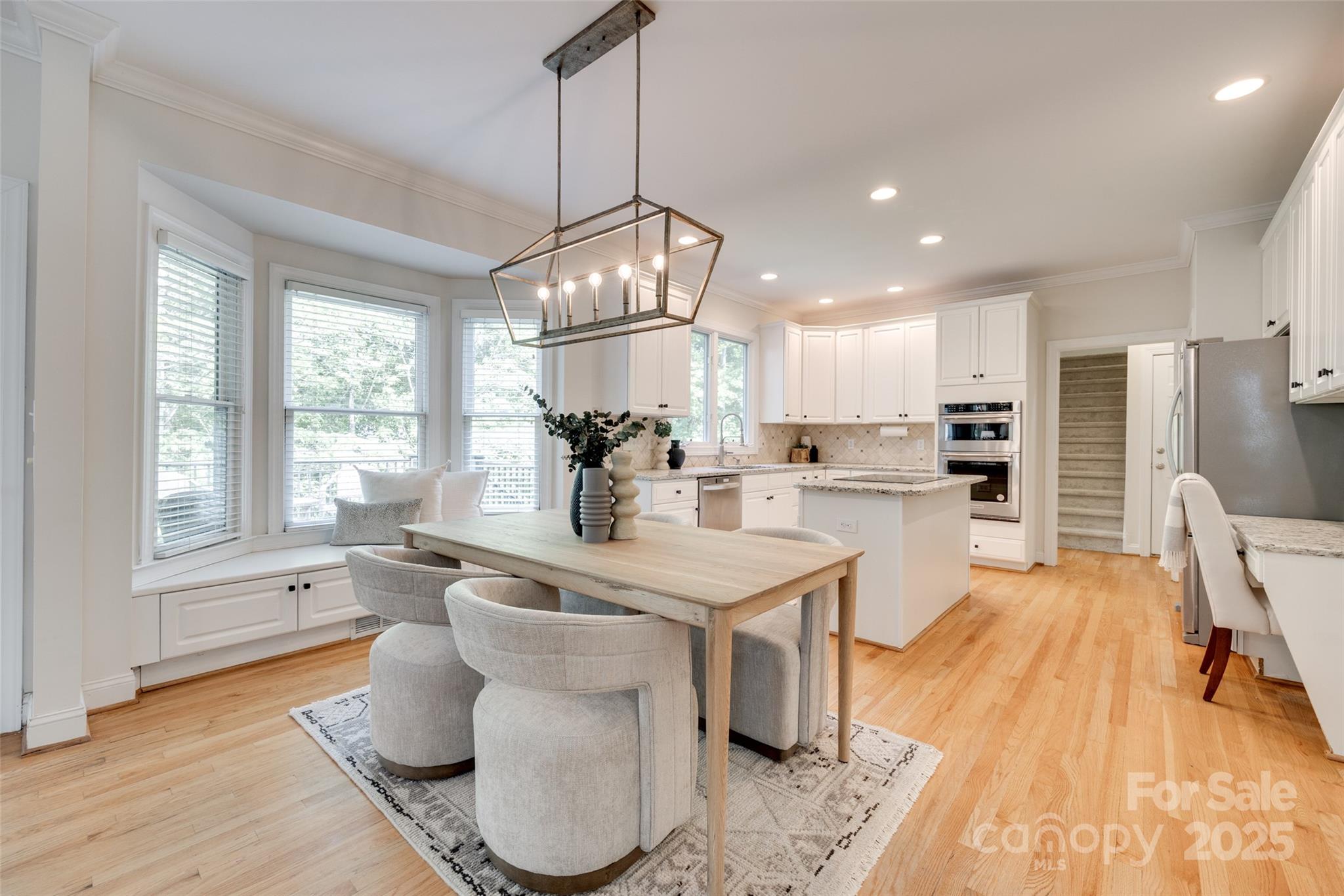 6804 Riesman Lane Charlotte, NC 28210 - Photo 10 of 46 a kitchen with stainless steel appliances granite countertop a sink a stove a refrigerator and island with wooden floor