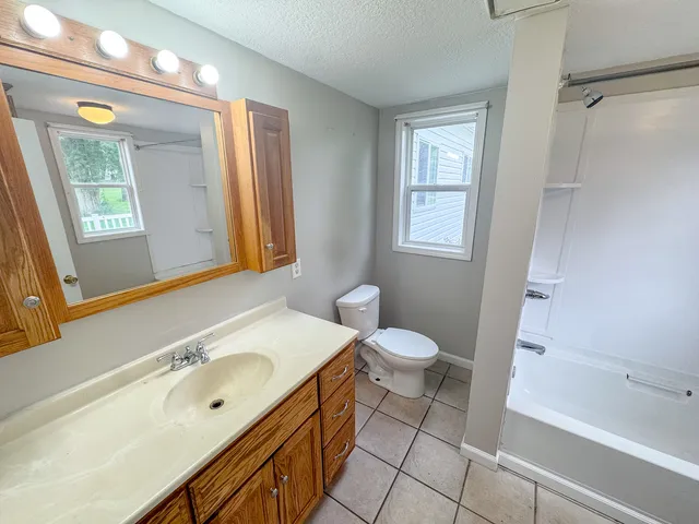 a bathroom with a tub and a shower