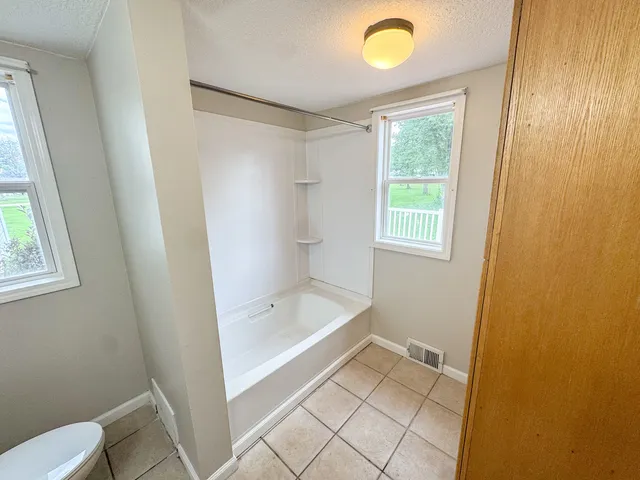 a bathroom with a sink a mirror and a shower