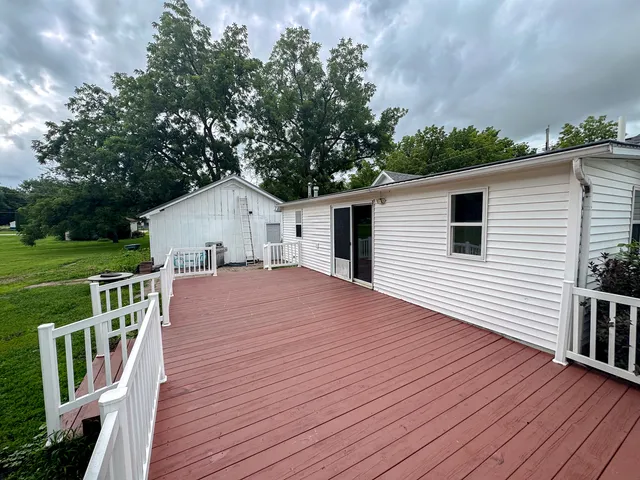 a view of a deck with a big yard