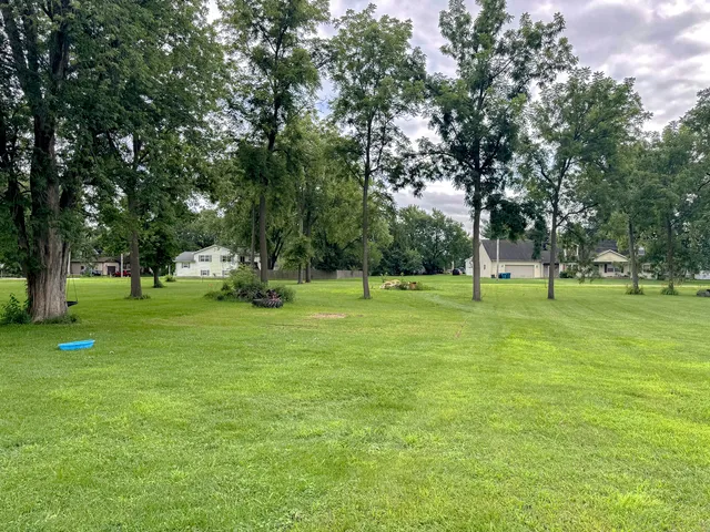 a huge green field with lots of trees