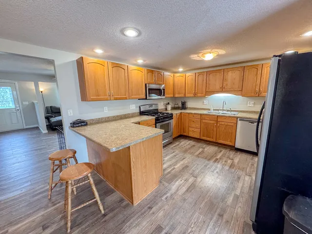 a kitchen with a sink a counter top space and appliances