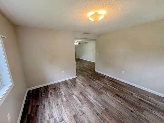a view of an empty room and wooden floor