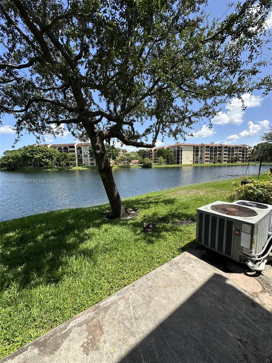 10003 Winding Lake Road, Unit 103 Sunrise, FL 33351 - Photo 12 of 12 a view of a lake with houses