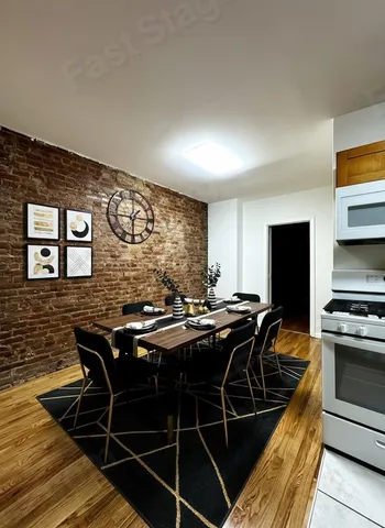 a kitchen with granite countertop a sink and wooden cabinets