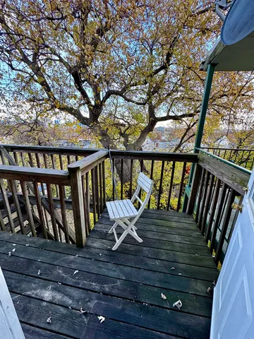 a view of a balcony with wooden floor