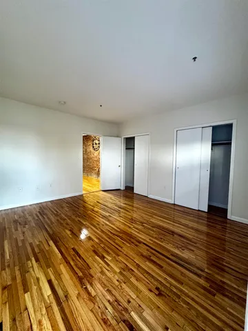 a view of an empty room and wooden floor