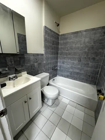 a bathroom with a sink a toilet and bathtub