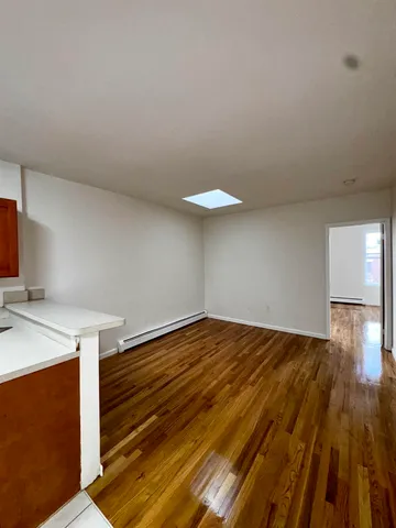 a view of a room with wooden floor and sink