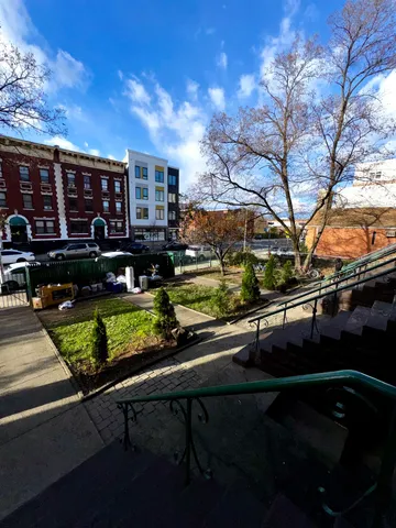 a view of house with swimming pool and outdoor seating