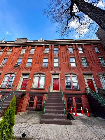 a view of a brick building with many windows