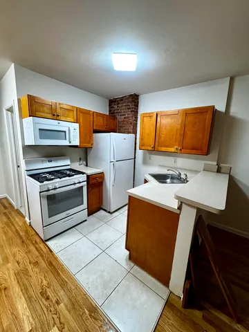 a kitchen with stainless steel appliances a stove a sink and a microwave