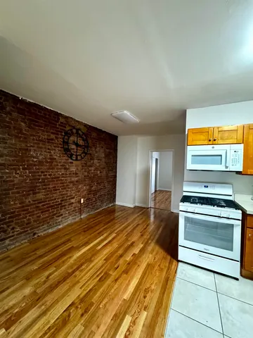 a view of a kitchen with a sink and a stove top oven