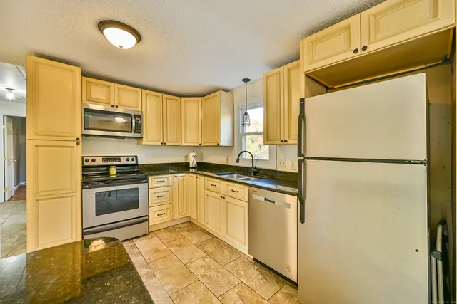 a kitchen with a refrigerator and a sink