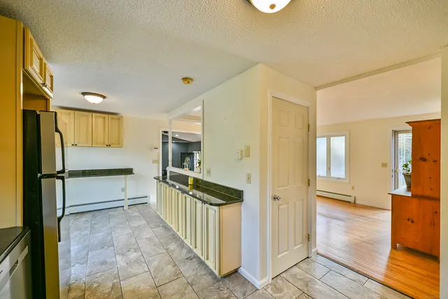 a kitchen with stainless steel appliances granite countertop a refrigerator and a sink