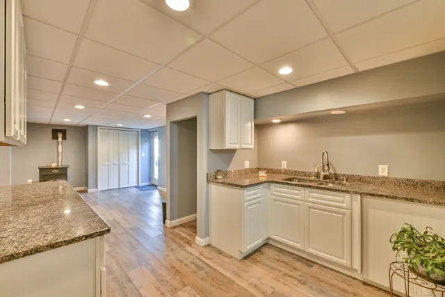 a kitchen with stainless steel appliances granite countertop a sink stove and cabinets