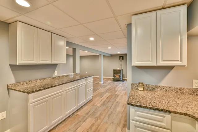 a view of a hallway with two sinks and a refrigerator