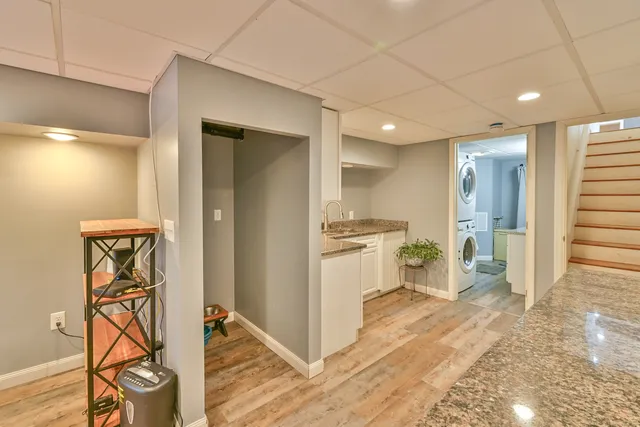 a view of a kitchen with a sink and a refrigerator