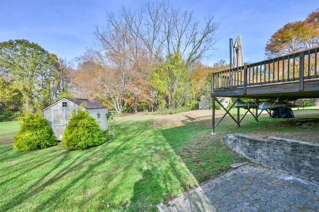 a view of a house with backyard and a patio