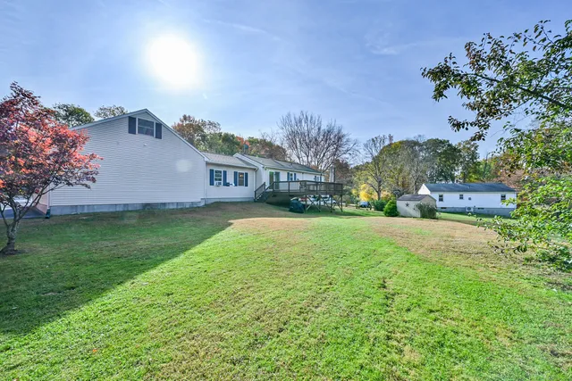 a house view with swimming pool and garden space