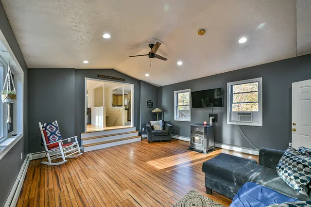 a living room with furniture and a wooden floor