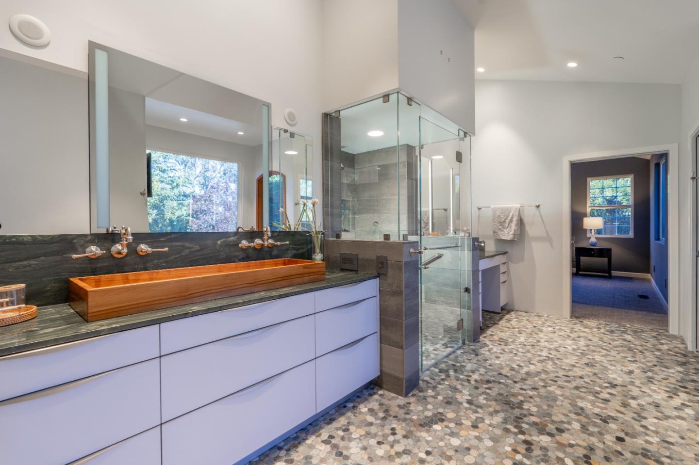 23715 Determine Lane Monterey, CA 93940 - Photo 25 of 43 a bathroom with a sink a large mirror and a shower