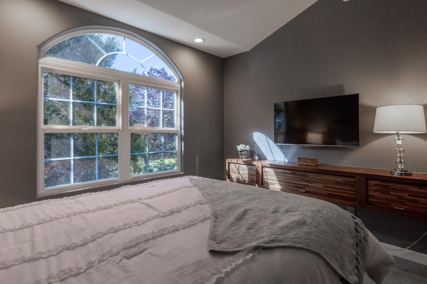 23715 Determine Lane Monterey, CA 93940 - Photo 32 of 43 a bedroom with a large bed and a flat tv screen on dresser